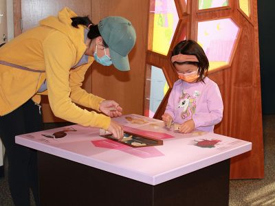 A mother and child explore hydrothermal vent communities as part of a “Life on the Edge” activity. 