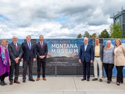 An esteemed group posing a the construction site of the new Montana Museum of Art and Culture.