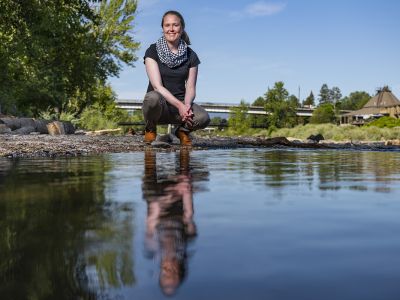Photo of Hilary Marten standing by the Clark Fork River