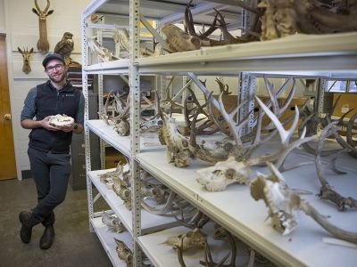 A picture of Connor Meyer holding a wolf skull.