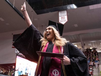 A UM student celebrates graduating. 