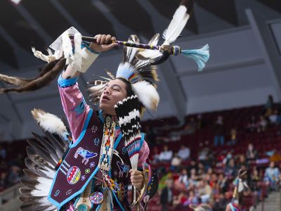 A male dancer gestures at the 2022 Kyiyo Pow Wow.