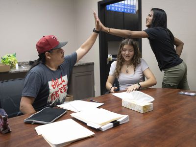 Ronan High School student Aaliyah Steward high-fives Stephan Chase, Montana American Indians in Math and Science associate director, during a grade check. 