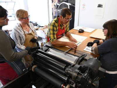 Photo of students around printing press