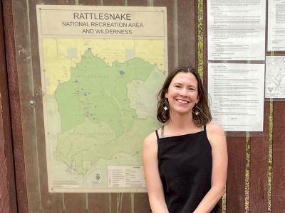 UM graduate student Elena Thomas poses at the trailhead for the Rattlesnake National Recreation Area and Wilderness near Missoula.