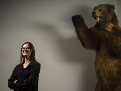 Ruby Schipf stands with grizzly bear. 