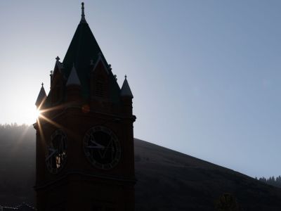A picture of the sun rising behind Main Hall