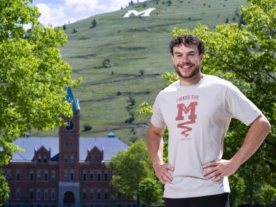 Man stands on 91Ԫ Oval with new M Trail shirt