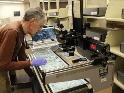 Volunteer John Pierce works with images.