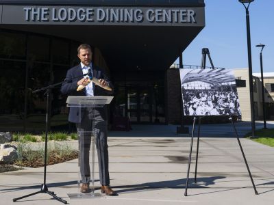 UM President Seth Bodnar breaks bread in front of the new UM Lodge dining hall.