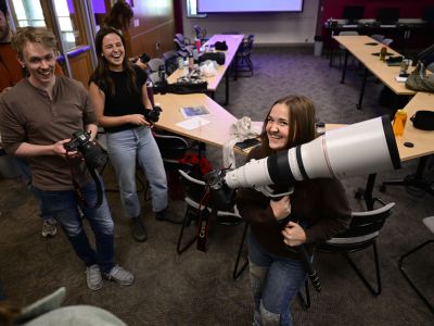 Ella Palulis, a sophomore at UM, smiles with equipment she will be using during the UM Journalism School’s innagural photography workshop. UM students and early career photojournalists from across the nation came to campus for the photography intensive. 