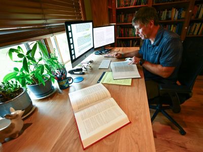 A picture of Craig Rigdon studying at his table.