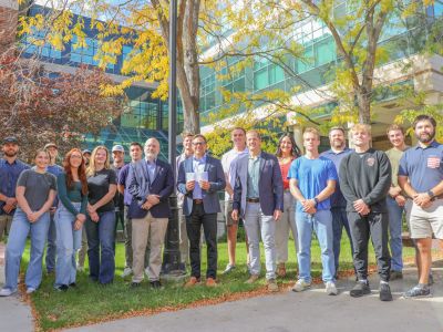 Frank D’Angelo, senior vice president and Missoula branch manager of D.A. Davidson, presents students from the UM College of Business with over $8,787 