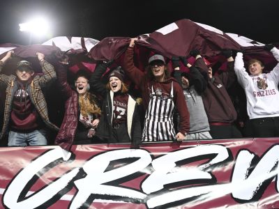 Zoo Crew members cheer at a Griz football game.