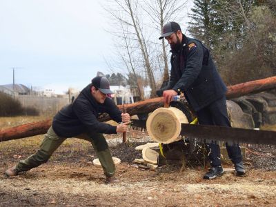 Jared Landin and Alex Kaper saw a log.