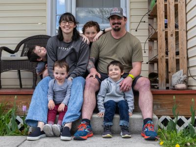 Keely McFarren sits on his front porch in Missoula with his wife and their four children.