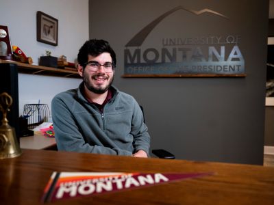 UM Student Ryan Fleetwood sits at a desk on the UM campus.