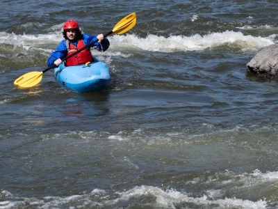 A student in UM’s whitewater kayaking class paddles through faster moving water during the class’s first day on moving water at Sha-Ron Fishing Access Site on the Clark Fork River.
