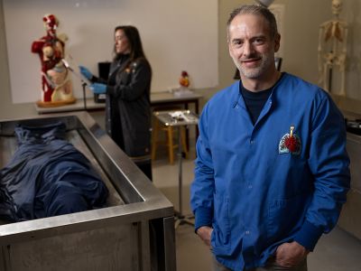 A picture of Lucas Whitcher with a body in the Cadaver Lab.
