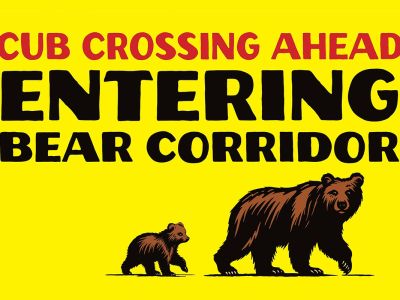 A sign that says: Cub Crossing Ahead. Entering Bear Corridor.