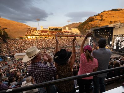 Concert goers wave during a show at Washington-Grizzly Stadium.