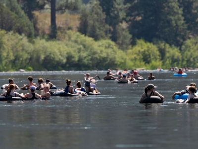 An image of people floating in tubes on the river. 