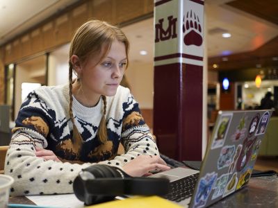 A female UM student studies in the University Center.
