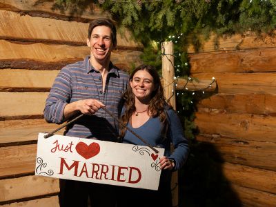 Kelsey Miller and Luke Rymniak hold a "Just Married" sign at the Foresters' Ball.