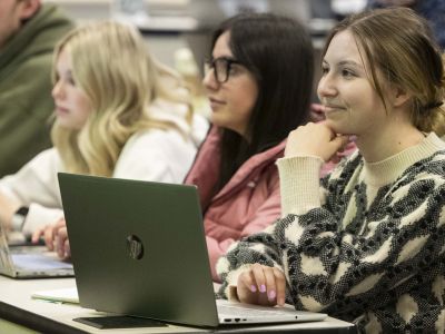 Students sit with their laptops in a UM class. 