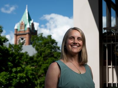 A picture of Rachel Severson with the Main Hall clocktower behind her.