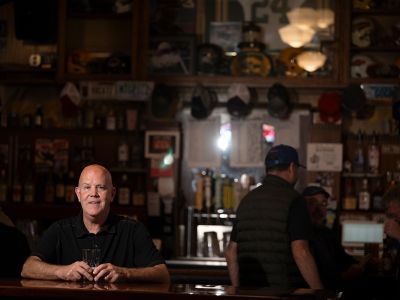 Mike Helean poses at the bar in Red's.