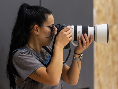 An image of UM journalism student Casandra Evans holding a camera. 
