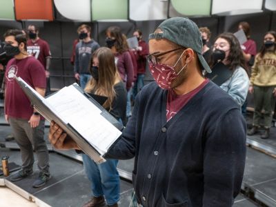 A man sings with a mask on 