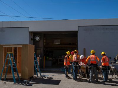 Students in surround a construction table at Missoula College 