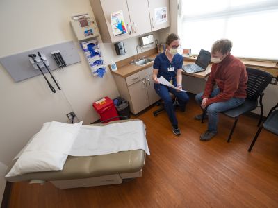Two people talk in a medical office 