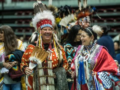 Two women talking at a powwow 
