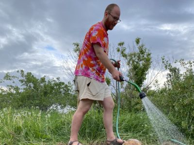 kaleb watering rock garden