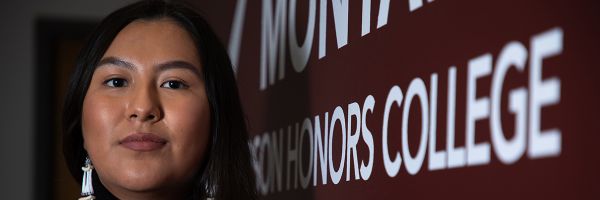 headshot of a student next to a sign for the Davidson Honors College
