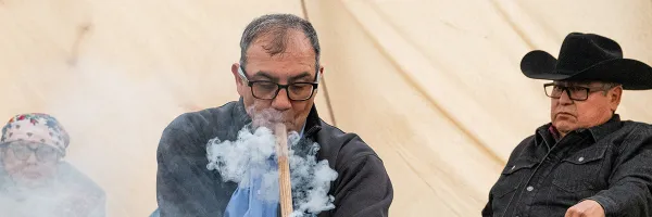 Tyson Running Wolf begins a pipe ceremony with distinguished delegation from the Blackfoot Confederacy on the Oval on the University of Montana campus.