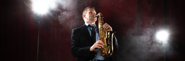 Person playing a saxophone on stage