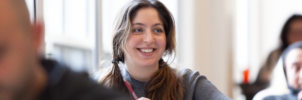 smiling student in a classroom 