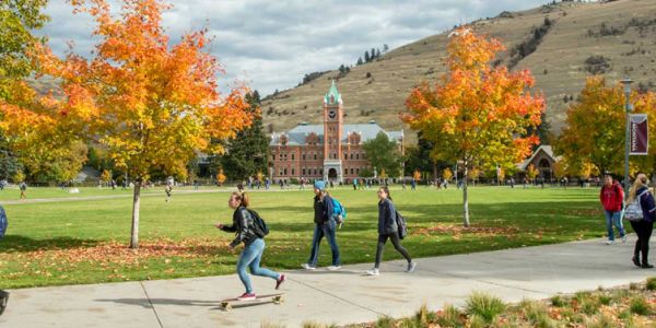 Students make their way around the Oval at UM in the fall.