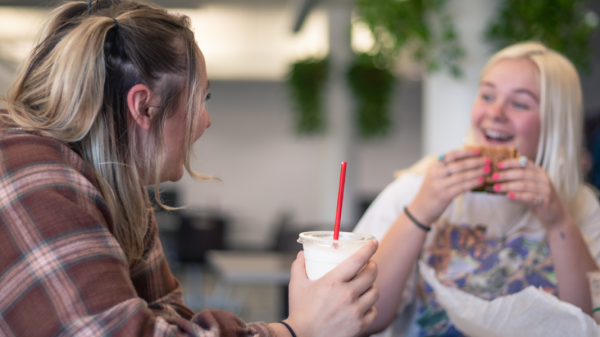 Students eating and laughing