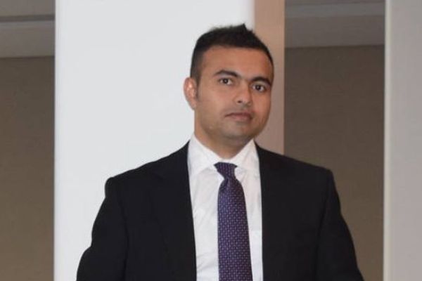 Dr. A B M Shamim Ul Hasan standing in a suit