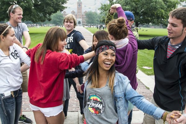 bonding activity at freshman orientation with people smiling and holding hands