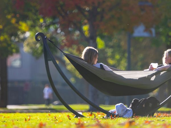 Two students share a hammock on the Oval
