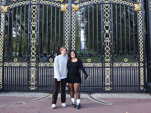 UM senior Joe and a new friend stand in front of ornate gates in Ireland