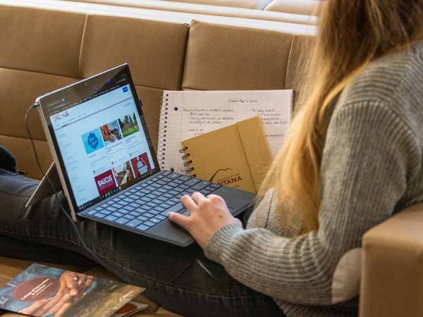 A UM student works online on a laptop