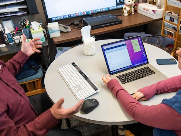 UM student Amanda Jennings, right, works on her medical school application with PreMedical Sciences Director Mark Pershouse.