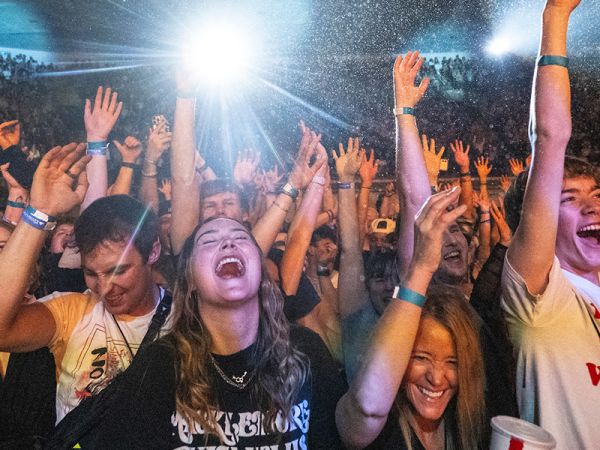 Concertgoers dance at a show in the Adams Center at UM